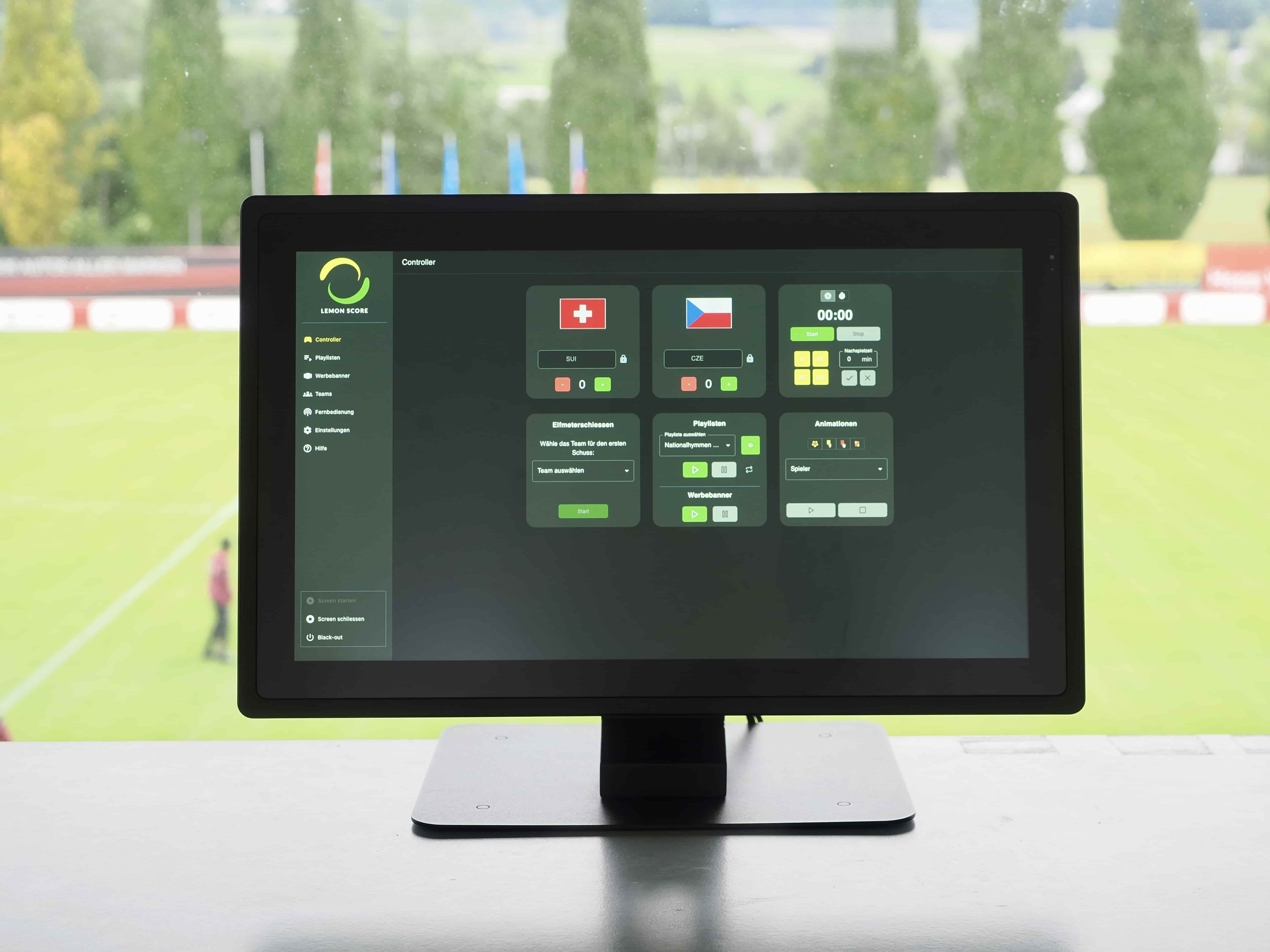 LemonScore controller on a screen in the announcer booth overlooking the pitch