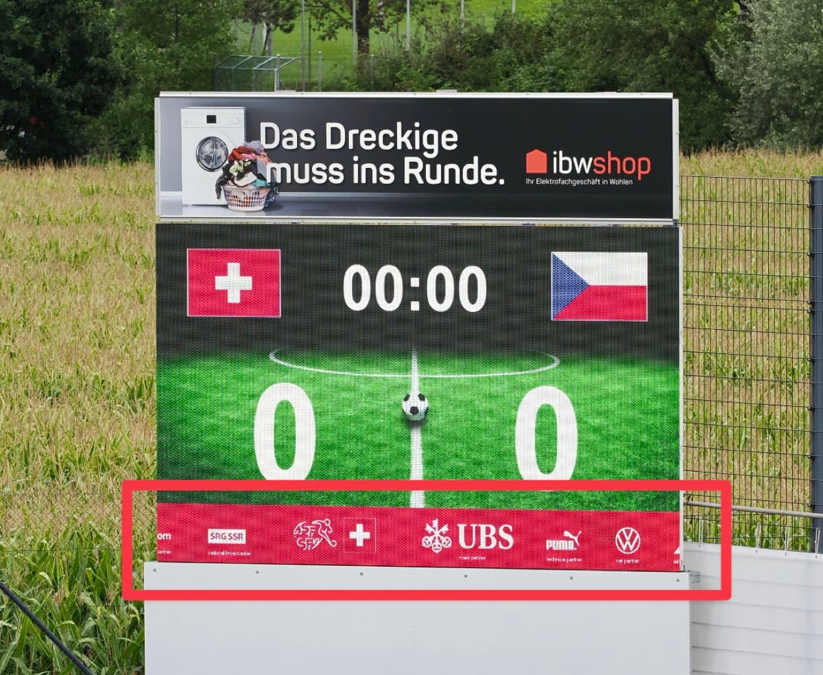 Advertising banner with sponsor logos along the bottom edge of the LED scoreboard, highlighted in red