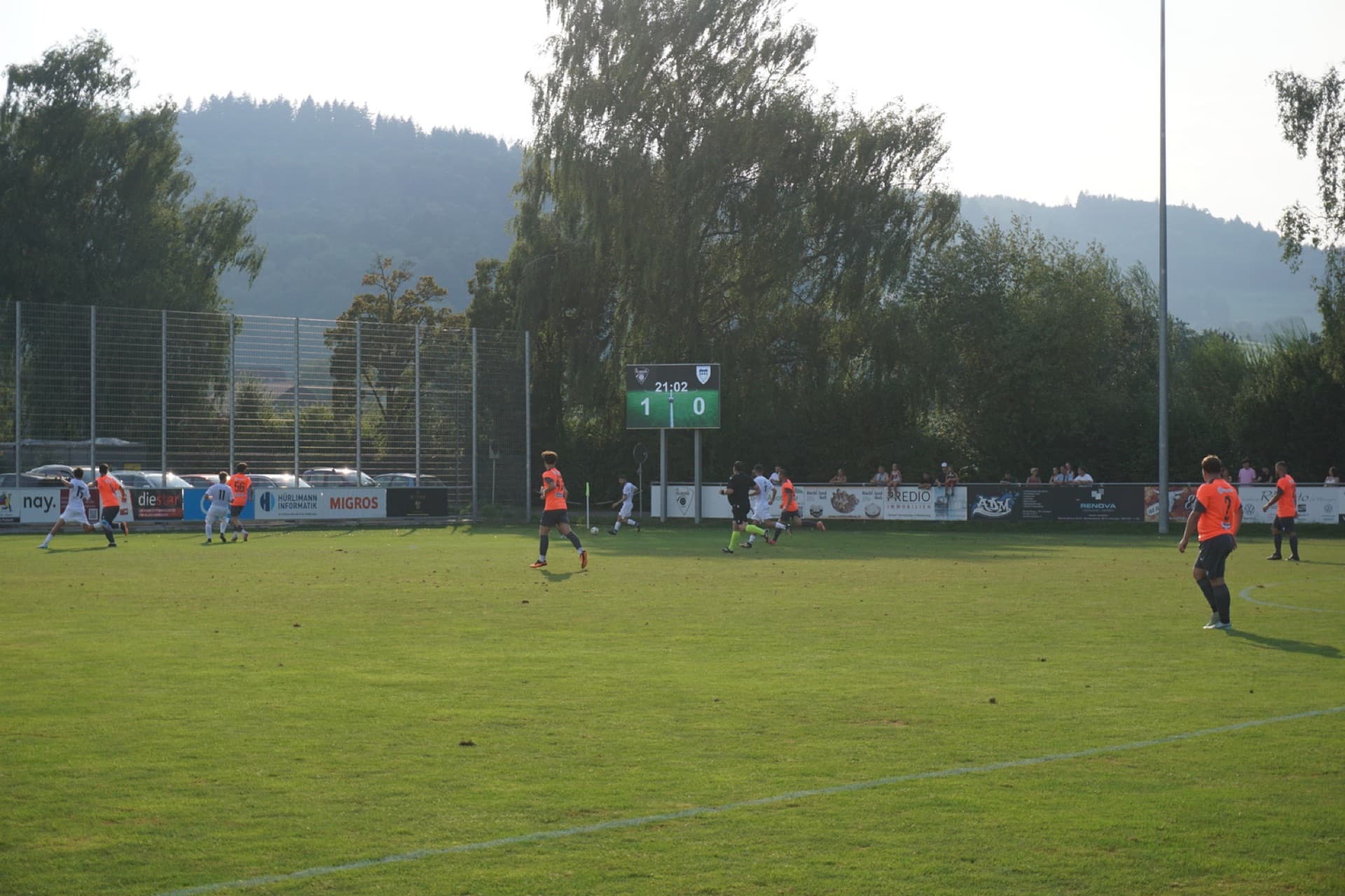 Digital scoreboard on the sideline of a Swiss club ground showing the score and the match clock